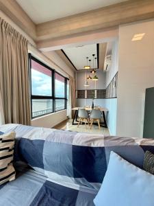 a bedroom with a bed and a table with chairs at Arte Plus Jalan Ampang KLCC in Kuala Lumpur