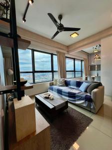 a living room with a couch and a ceiling fan at Arte Plus Jalan Ampang KLCC in Kuala Lumpur