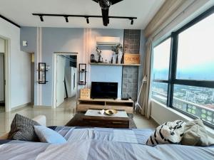 a bedroom with a bed and a living room at Arte Plus Jalan Ampang KLCC in Kuala Lumpur