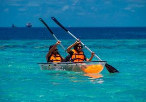 two people are in a kayak in the water at iHaven Thulusdhoo in Thulusdhoo