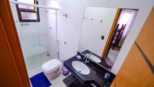a bathroom with a sink and a toilet at Chalé Amarelo in Itanhaém