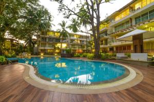 a swimming pool in front of a building at Eternal wave by HappyInch in Calangute