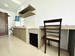 a chair sitting at a counter in a kitchen at Super Deluxe Apartment with Skypool Medan in Sunggal