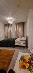 a bedroom with a bed and a chandelier at Trundle bed- with office desk, small room in Newhaven