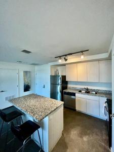 a kitchen with white cabinets and a granite counter top at Downtown Haven of the City in Phoenix