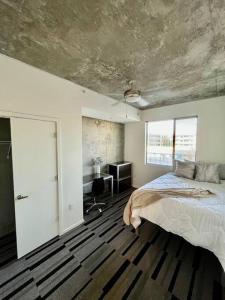 a bedroom with a large bed and a window at Downtown Haven of the City in Phoenix