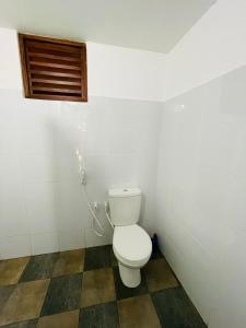 a bathroom with a toilet in a room at JM resort in Trincomalee