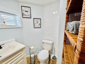 a bathroom with a toilet and a sink at Ultra Modern - Entire 3 Bedroom Apartment - 5 min walk to the Beach in Wildwood