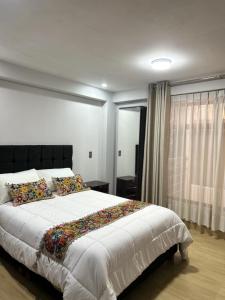 Postel nebo postele na pokoji v ubytování Skyhousecusco
