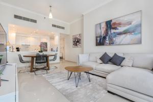 a living room with a couch and a table at Perfect 2BD apartment in the heart of Marina - top spot in Dubai