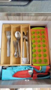 a toy drawer with utensils in a toy kitchen at Aparta estudio Colorido in Bogotá