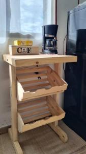 a small wooden table with a coffee maker on it at Aparta estudio Colorido in Bogotá