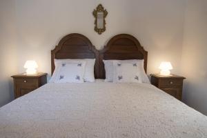 a bedroom with a large bed with two night stands at Villae Dalmaticae - Plava in Sumartin +33 photos