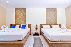 Postel nebo postele na pokoji v ubytování Aonang Privacy Resort