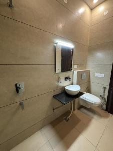 a bathroom with a sink and a toilet at HOTEL ANANTA in Ambāla