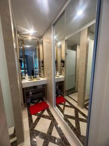 a bathroom with two sinks and two mirrors at Espana Condo Resort Pattaya F108 in Jomtien Beach