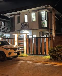 a car parked in front of a house with a gate at Exclusive Midori Paradise in Minglanilla