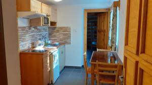 a small kitchen with a sink and a counter at Apartmán U Pekařů in Pec pod Sněžkou