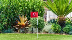 a red flag in the middle of a garden at Watersea By The Bay Unit 2, waterfront, walk to shop&restaurants in Umina
