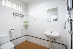a white bathroom with a sink and a toilet at Seaside Private Bungalow, Tg Bungah in Tanjung Bungah