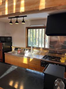 a kitchen with a sink and a stove top oven at King's house in Hakuba