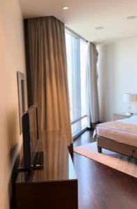 a bedroom with a bed and a flat screen tv at Burj Khalifa in Dubai