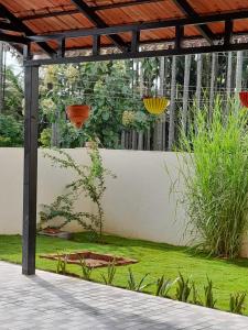 a garden with a pergola and green grass at A Chettinad villa in Coimbatore in Coimbatore