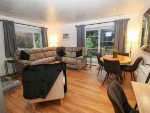 a living room with a couch and a table at Llety'r Wyddfa in Caernarfon