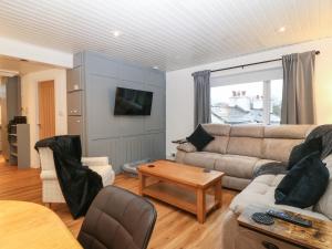 a living room with a couch and a table at Llety'r Wyddfa in Caernarfon