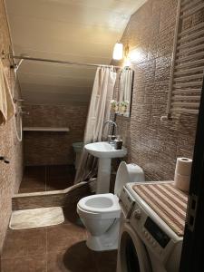 a bathroom with a toilet and a sink at Beautiful Apartment on Atoneli in Tbilisi City