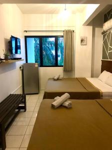 Postel nebo postele na pokoji v ubytování Pangkor BeachWalk Studio
