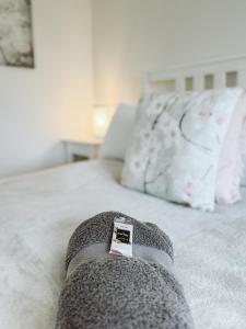 a sock on top of a bed with a pillow at "On Burgum Pond" Cottages in Maleny