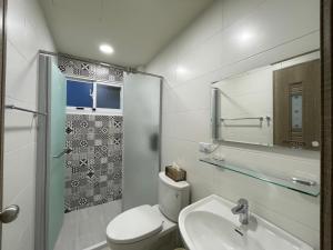 a bathroom with a toilet and a sink and a shower at 慢慢相遇 in Taitung City