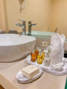 a bathroom with a sink and a counter top with a sink at Western Hotel Liwa in Liwa