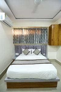 a bedroom with a large bed in a room at HOTEL GOLDEN CITY in Surat