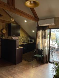a kitchen with black cabinets and a table and chairs at Beautiful Apartment on Atoneli in Tbilisi City