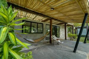 a porch with a hammock in a house at Costa Lanta - Adult Only in Ko Lanta