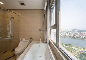 a bathroom with a bath tub and a window at The Vinhomes Central Park Apartments - The Buildings Surrounding Landmark 81 in Ho Chi Minh City +165 photos