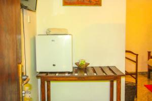 a small refrigerator sitting on a table in a room at Kolon Resort Sigiriya in Sigiriya