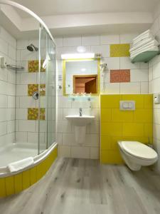 a bathroom with a sink and a shower and a toilet at Guest House Mlada lipa in Maribor