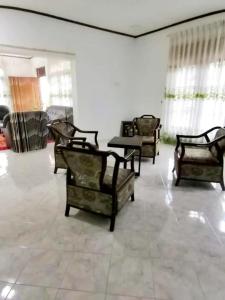 a living room with several chairs and a table at Mountain Paradise Homestay in Bandarawela