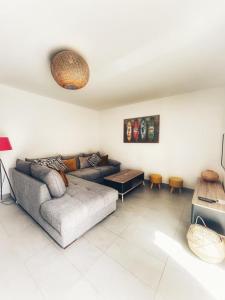 a living room with a couch and a table at Villa Orethaga Piscine 10 pers porto Vecchio in Porto-Vecchio