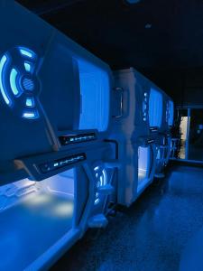 a row of seats in a bus with blue lights at CAPSULE INN VALENCIA Hostel in Valencia