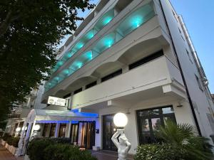un edificio con luci blu sopra di esso di Hotel Perla a Cesenatico