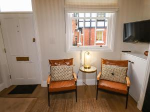 a living room with two chairs and a window at 4 Albion Place in Chester