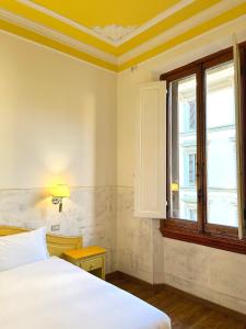 a bedroom with a bed and a window at Hotel Duca D'Aosta in Florence