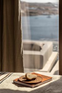 a plate with a piece of bread on a table at The Skyvilla Mykonos - A Landmark Property with Breathtaking Views of the Psarou bay in Mikonos