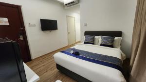 Postel nebo postele na pokoji v ubytování The Penthouse and Suite SGR Melaka