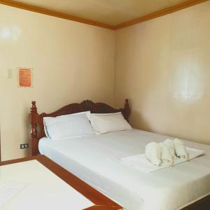 a bedroom with two beds with towels on them at D'MESA Seacretlodge and Restaurant in Taytay