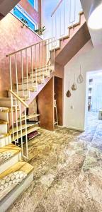 a spiral staircase in a room with a stone floor at Sal Apart in Timişoara